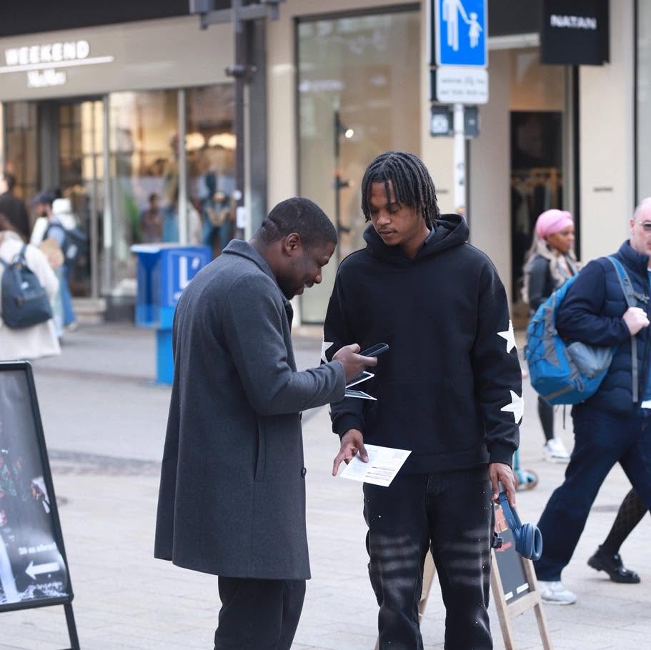 LCC members speaking with a young person during city outreach
