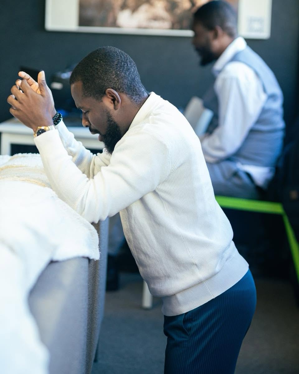 Men praying together at Luxembourg City Church