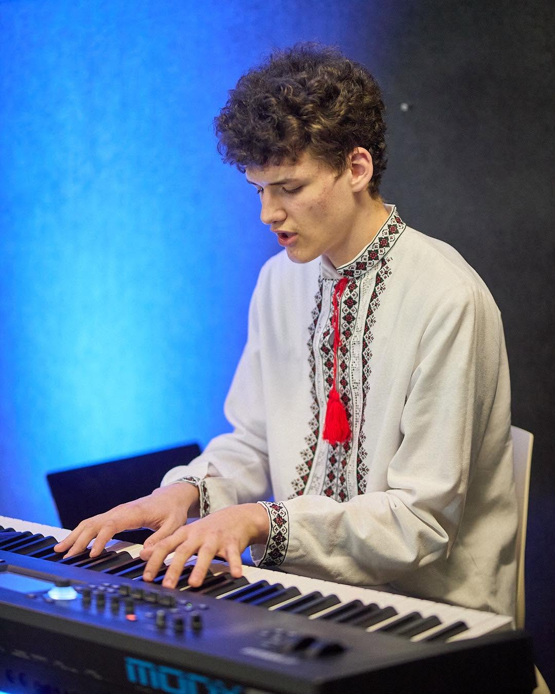 A young musician playing keyboard during an LCC gathering
